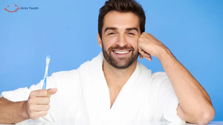 Confident man holding a toothbrush & smiling. Featured image for a blog about choosing oral care tools. Represents healthy, clean, & confident dental hygiene.