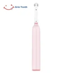 Grin Teeth ET 6A rotating oscillating electric toothbrush rear view showcasing slim ergonomic handle and soft pink finish