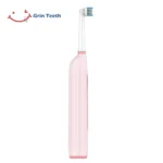 Grin Teeth ET 6A rotating oscillating electric toothbrush full side profile in pink, showing slim handle and round brush head