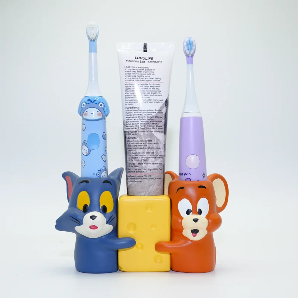 Tom and Jerry ceramic toothbrush holder holding kids’ electric toothbrushes and toothpaste