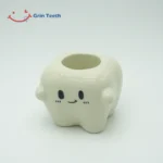 Tooth-shaped ceramic electric toothbrush holder with 1 slot, front view