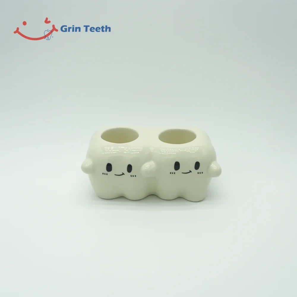 Back view of tooth-shaped ceramic electric toothbrush holder with 2 slots