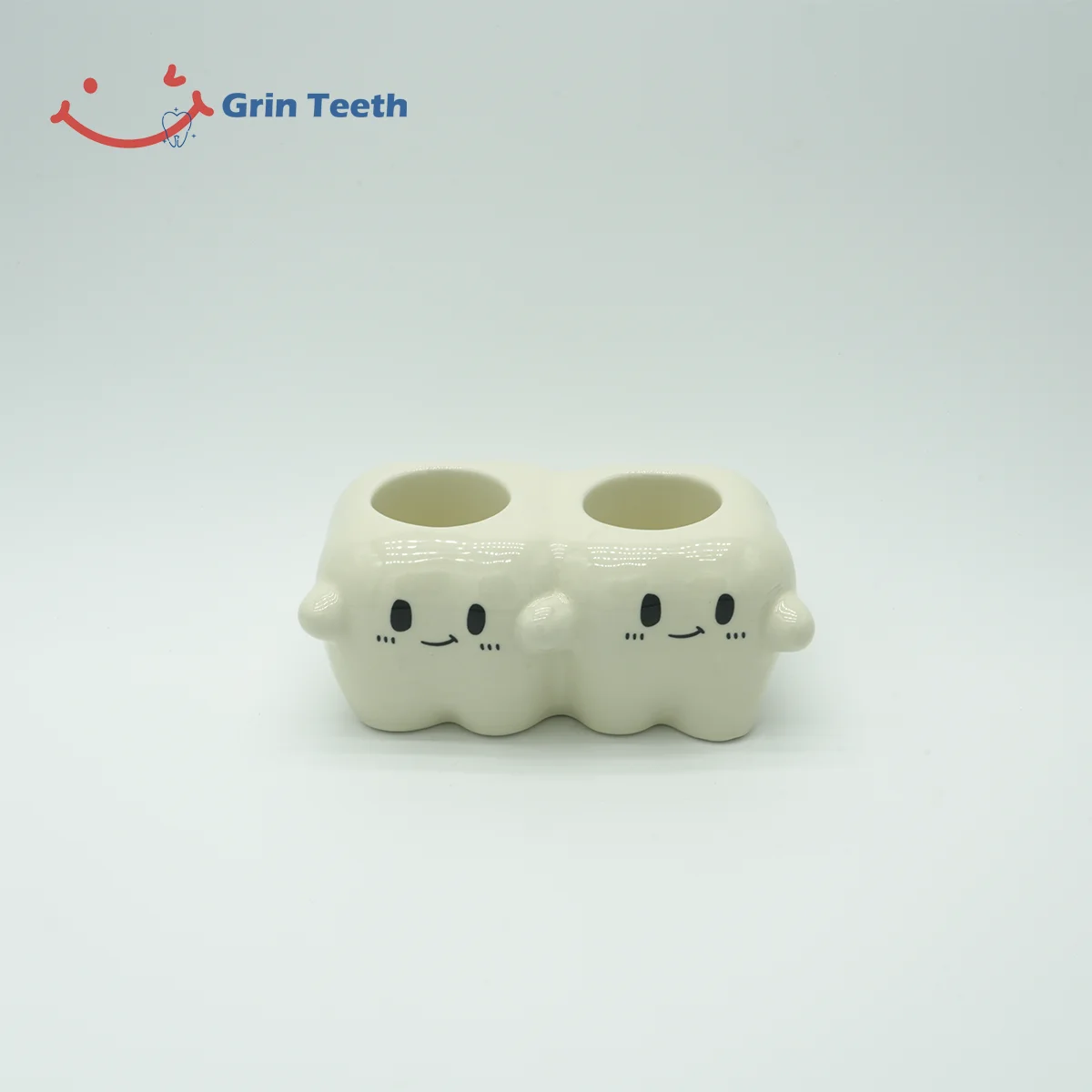 Back view of tooth-shaped ceramic electric toothbrush holder with 2 slots