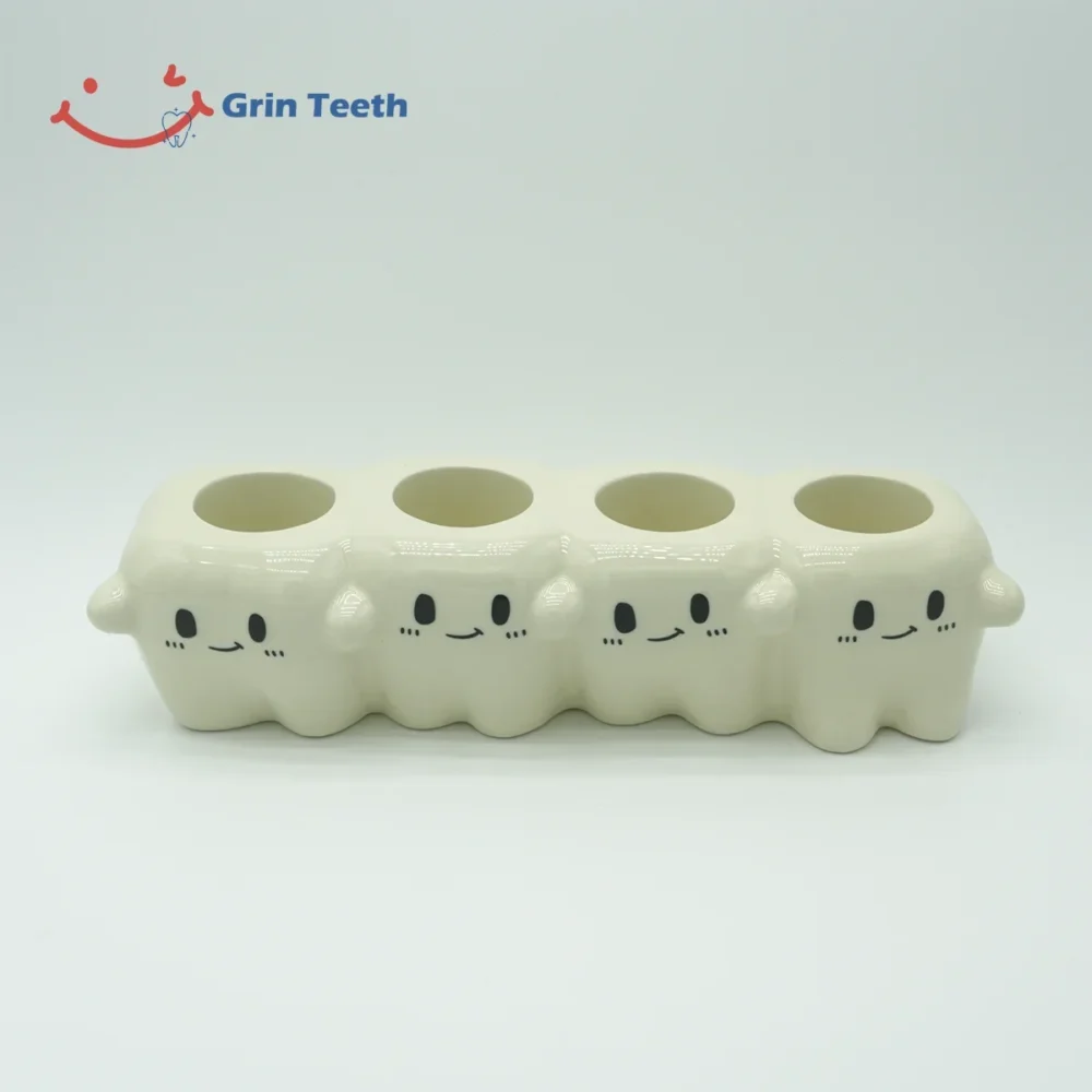 Close-up of four-slot cute tooth-shaped ceramic electric toothbrush holder