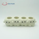 Close-up of four-slot cute tooth-shaped ceramic electric toothbrush holder