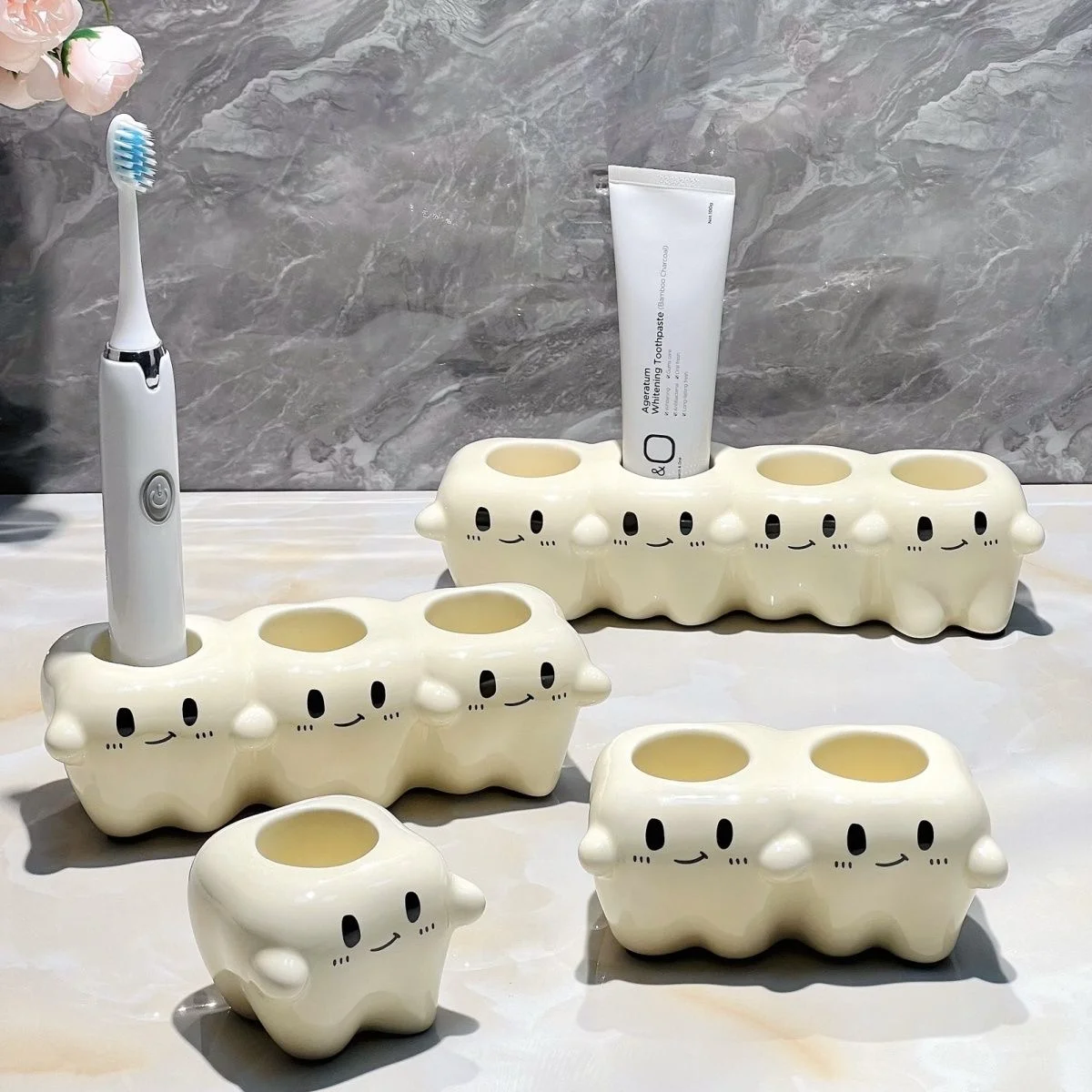Tooth Inspired Electric Toothbrush Holder Set for Daily Care Tooth-Inspired Electric Toothbrush Holders in 1 to 4-slot variations on a bathroom counter, holding toothbrush and toothpaste.