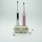 Tooth-inspired ceramic electric toothbrush holder with 2 electric toothbrushes inserted