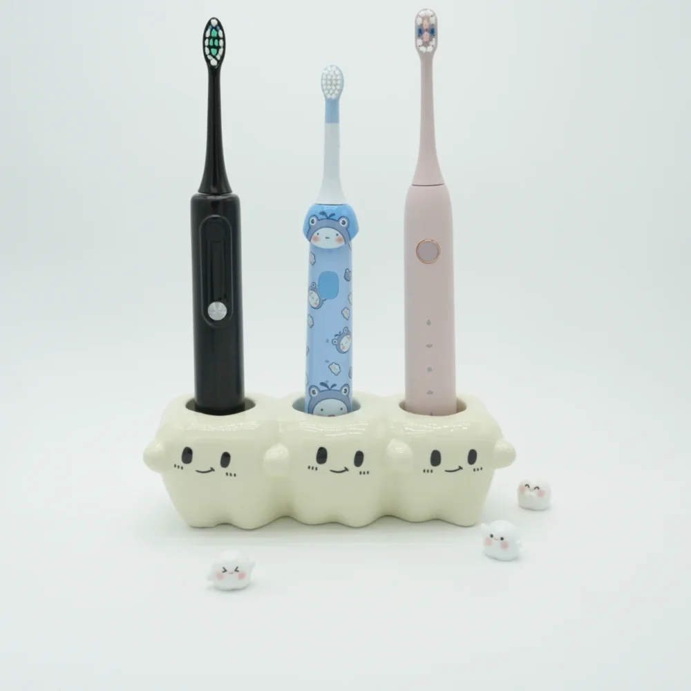 Ceramic tooth-inspired electric toothbrush holder organizing 3 colorful electric toothbrushes