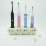 Tooth-inspired ceramic electric toothbrush holder organizing 4 colorful toothbrushes