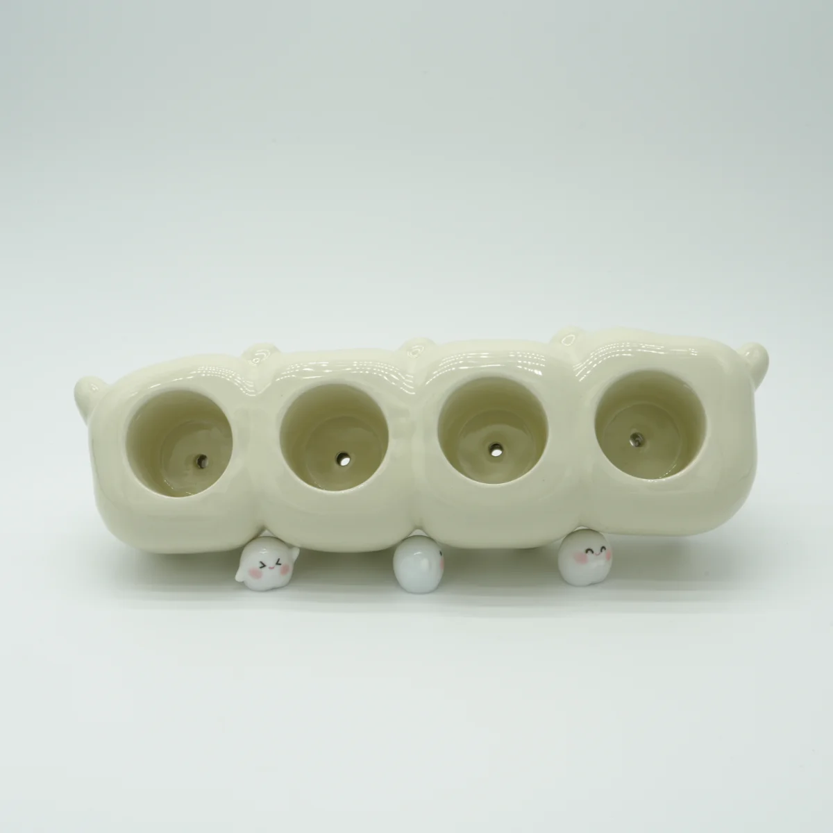 Tooth Inspired Electric Toothbrush Holder – Drainage View Bottom view of tooth-inspired electric toothbrush holder showing drainage holes and ceramic feet