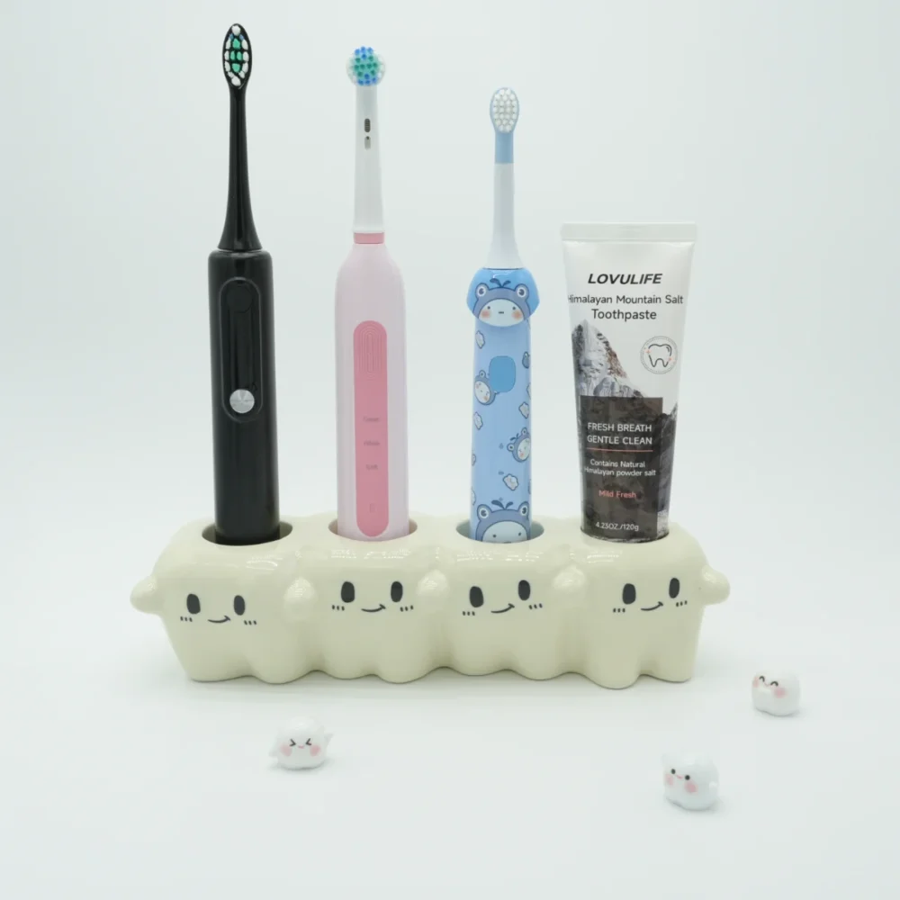 Tooth-inspired ceramic toothbrush holder organizing 3 electric brushes and 1 toothpaste