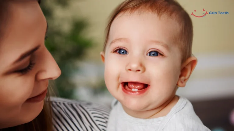 Smiling baby with first tooth – Baby teething symptoms and start