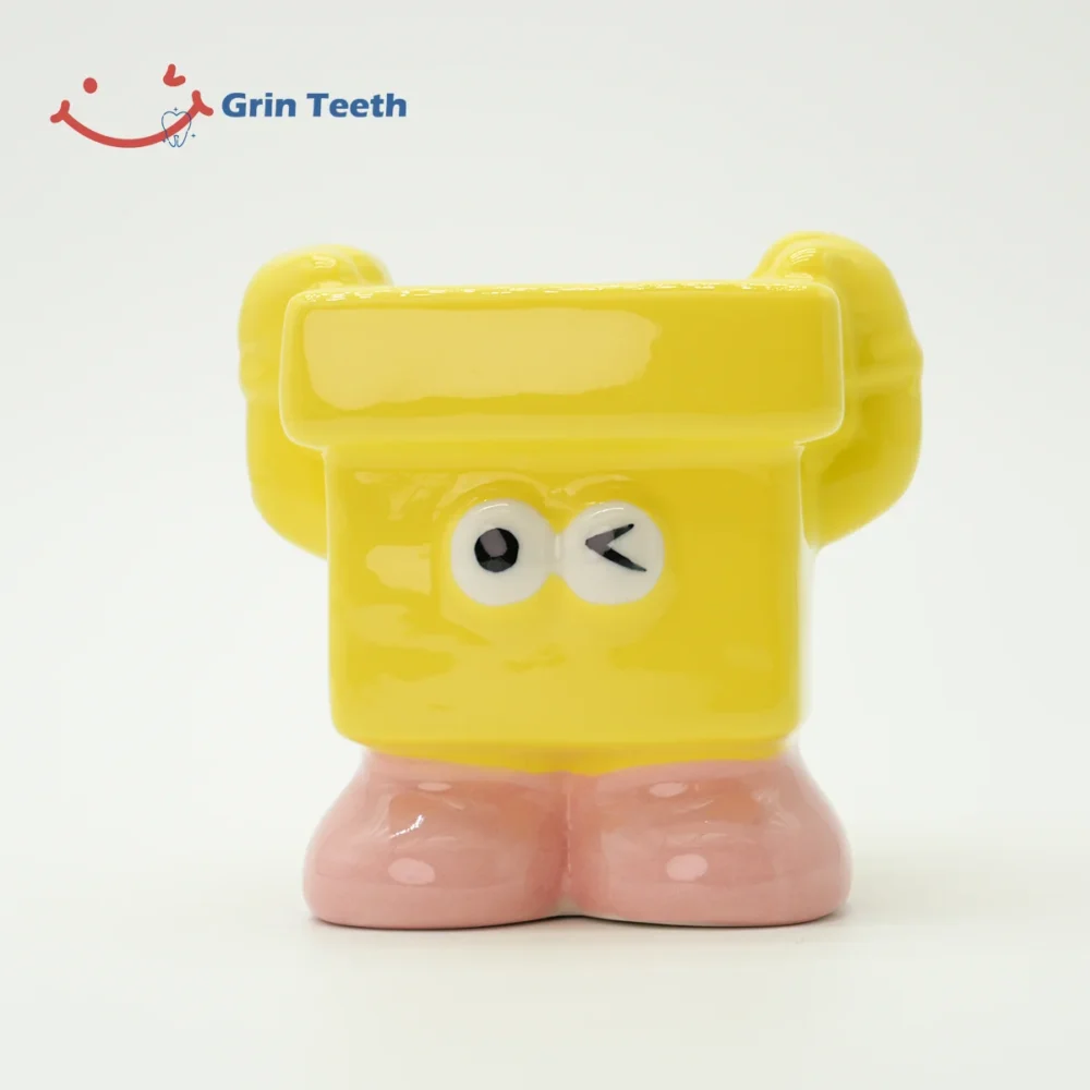 Yellow kids toothbrush holder with a playful wink design, encouraging fun brushing habits.