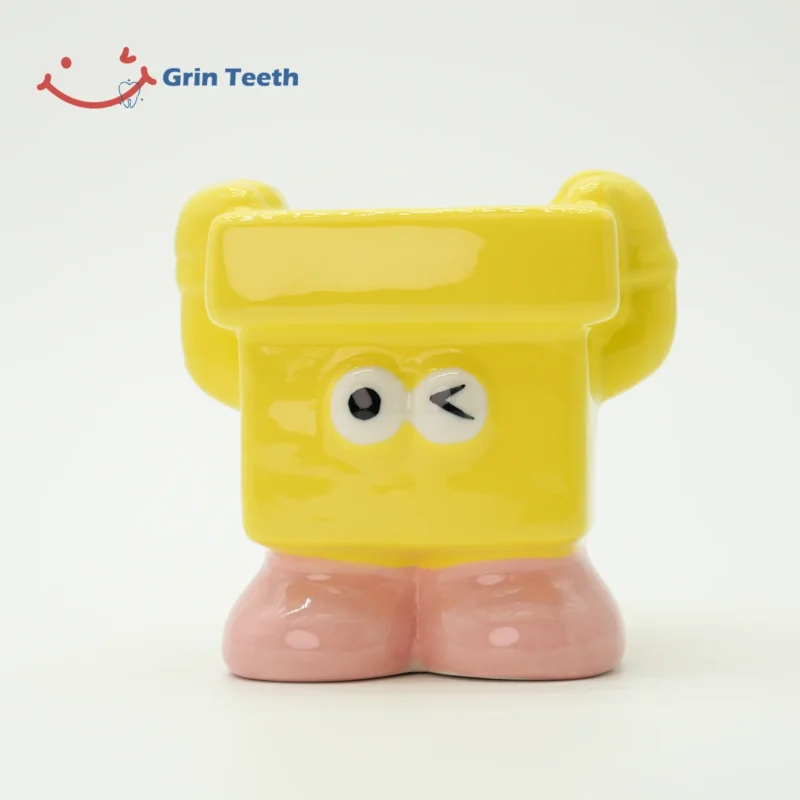 Yellow kids toothbrush holder with a playful wink design, encouraging fun brushing habits.