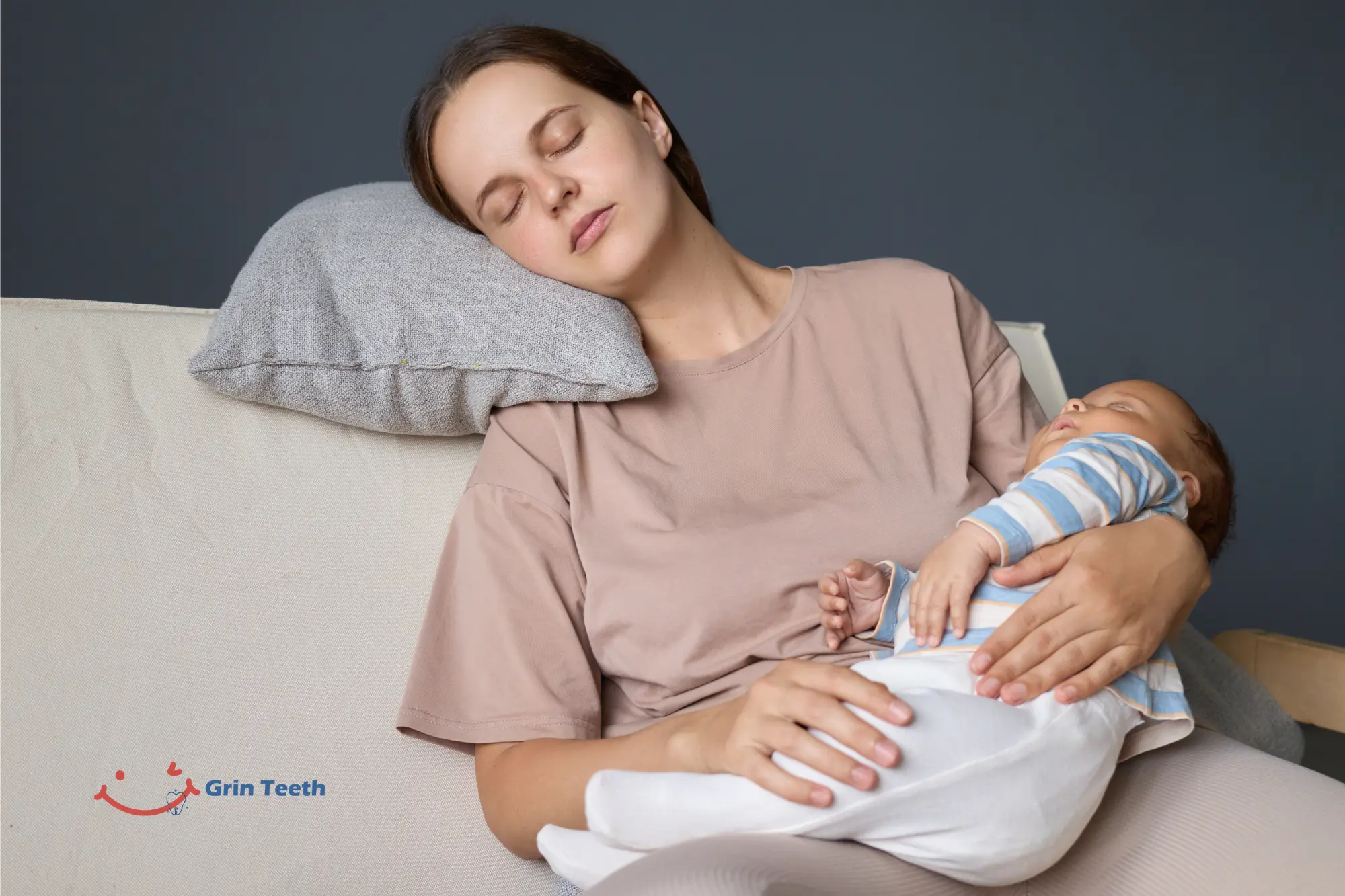 Do Babies Sleep More When Teething Sleepier Naps Nights Tired mom dozing on a couch while baby sleeps in her arms—Do Babies Sleep More When Teething? Image shows the “sleepier” teething pattern.