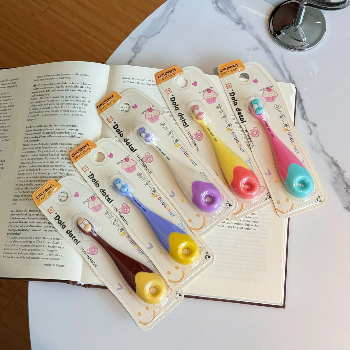 Shop Donut Toddler Toothbrush KT 3 Multi Color Set Four KT 3 donut toddler toothbrush packs on an open book; assorted colors, extra-soft bristles, donut ring easy-grip