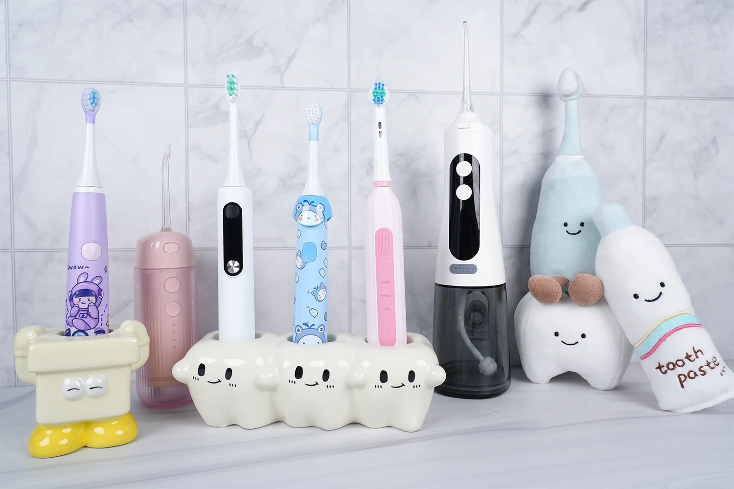 Grin Teeth teeth cleaning tools—kids & adult electric toothbrushes, water flosser and cute holders on bathroom counter